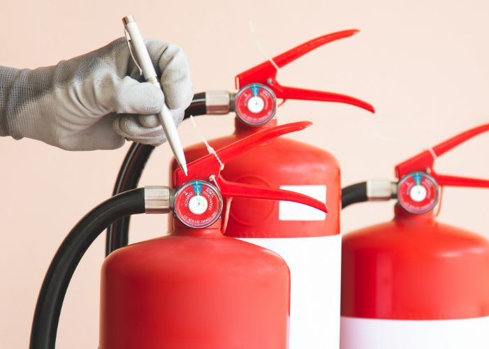 Gep Services El Extintor De Fuego Y El Bombero Chequean El Nivel Del Medidor De Presion - Gep Services